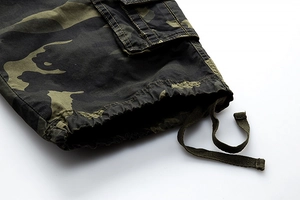 Detail view of camouflage cargo shorts featuring reinforced pockets and adjustable drawstrings