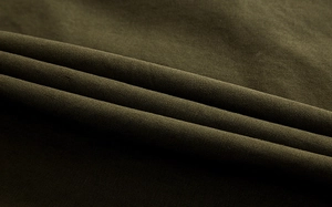 Detail of dark olive green twill cotton fabric with durable woven texture and soft drape