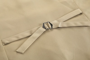 Macro shot of khaki suit vest adjustable back cinch with a silver metal buckle