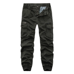 Detail of dark olive cargo pants featuring elastic drawstring waist and side flap pockets