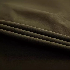 Macro shot of dark olive twill fabric texture on men's cargo shorts with visible weave
