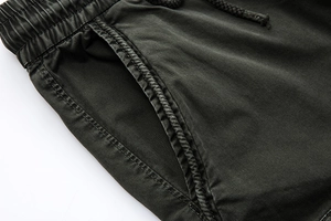 Detailed macro shot of elastic waist with drawstrings and side pockets on men's cargo pants