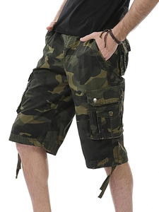Detail of camouflage cargo shorts featuring large side flap pockets and metal buttons