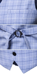 Detail view of light blue plaid vest showing chest pocket and adjustable back buckle