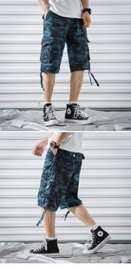 Detail of blue camouflage cargo shorts with multi-pocket design and adjustable drawstrings