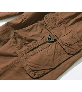 Detail of cargo pocket on tan cotton shorts featuring a black hook and durable double stitching