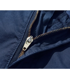 Detailed close-up of high-quality metal zipper on men's dark blue cargo shorts