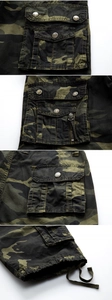 Detail view of army green camo cargo shorts featuring sturdy pockets and metal buttons