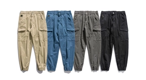 Detail of four men's jogger cargo pants in khaki, blue, grey, and black colors