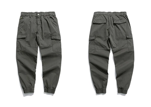 Detail of cargo jogger pants with side flap pockets and elastic cuffs in dark gray