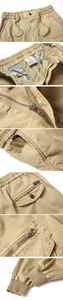 Detail of khaki cargo pants showing fabric texture, zipper pocket, and ribbed cuffs