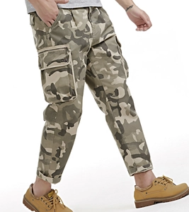 Detail of camouflage cargo pants with side flap pockets and military style cotton fabric