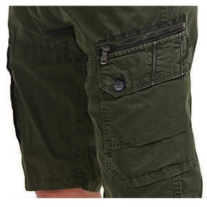 Detail view of military green cargo shorts featuring side pockets and a metal zipper closure