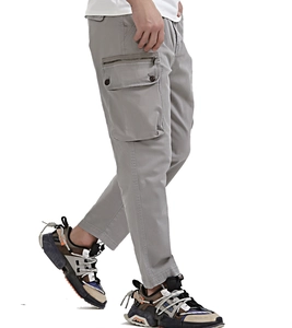 Detail view of men's grey cargo pants featuring side pockets with zippers and metal buttons