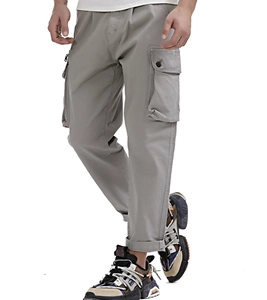 Detail view of men's grey cargo pants with side flap pockets and metal zipper details