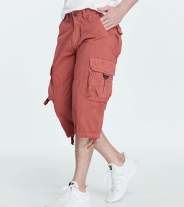 Detailed view of terracotta cargo shorts with functional flap pockets and drawstring hem