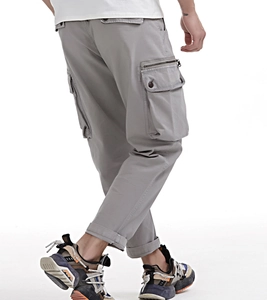 Detail view of men's loose cargo pants with side zipper pockets and tapered cuffs