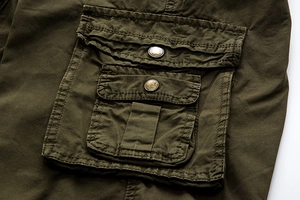 Detailed close-up of army green cargo shorts featuring 3D flap pockets and metal buttons