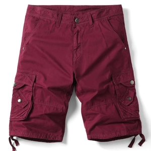 Detailed view of burgundy cargo shorts featuring functional side flap pockets and hem drawstrings