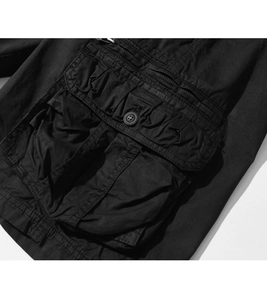 Detail of cargo shorts featuring a 3D pleated pocket with button and zipper closure