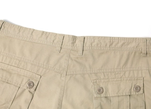 Detailed close-up of khaki cargo pants featuring button flap pockets and reinforced stitching