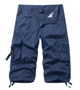 Detail of dark blue cargo shorts showing large flap pockets and hem drawstring adjustments
