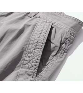 Close-up of grey cargo shorts with detailed double stitching and reinforced side pockets