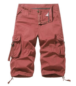 Detail view of brick red cargo shorts featuring utility flap pockets and drawstring hem