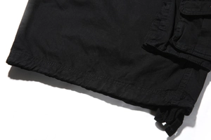 Detail of cargo pocket and stitching on black cotton canvas shorts for men