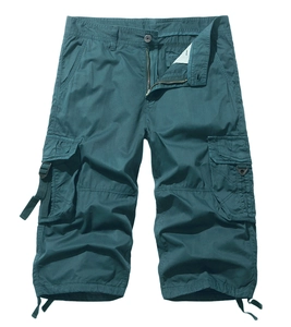 Detail of teal cargo shorts featuring large side pockets with strap and buckle accents
