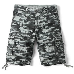 Detailed macro view of gray camouflage cargo shorts with side flap pockets and drawstrings