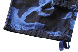 Close-up of blue camo cargo shorts featuring durable double stitching and adjustable drawstring