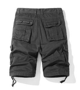 Flat lay of cargo shorts featuring durable cotton fabric, utility pockets, and leg drawstrings