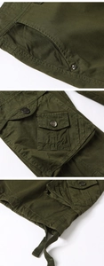 Close-up of military green cargo shorts featuring durable metal buttons and functional pockets