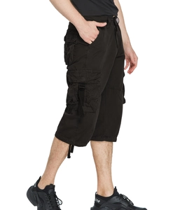 Detail view of black cargo shorts featuring large side flap pockets and buckle straps