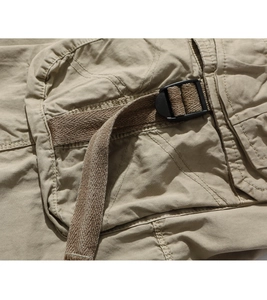 Detailed macro view of khaki cargo shorts pocket with durable cotton twill and buckle