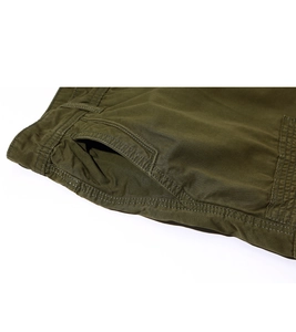 Detail of army green cargo shorts showing side pockets and premium twill cotton stitching