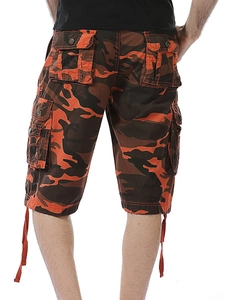 Detail of orange camouflage cargo shorts featuring buttoned back pockets and drawstring hem
