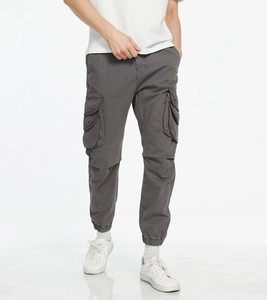 Close-up of large cargo pockets and durable fabric on men's dark grey joggers