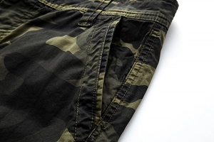 Detailed macro view of camo cargo shorts showing reinforced stitching and durable cotton fabric