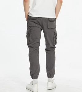 Detail view of cargo joggers featuring large rear flap pockets and elastic cuffs