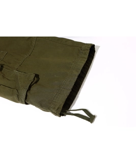 Detail of olive green cargo shorts featuring adjustable drawstring hem and side flap pockets