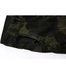 Close-up of jungle camouflage cargo shorts featuring reinforced stitching and pockets