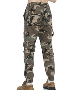 Detail of cargo pants showing camo pattern with back pockets and ankle zipper cuffs