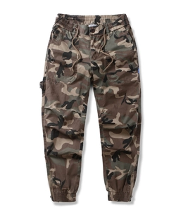 Detailed view of camouflage cargo pants with elastic drawstring waist and zipper hem