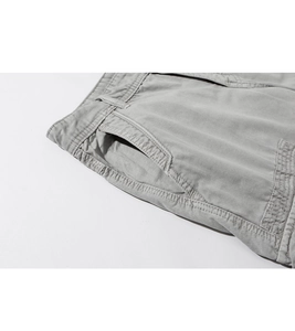Detail of light grey cotton twill men's casual shorts with reinforced side pocket stitching