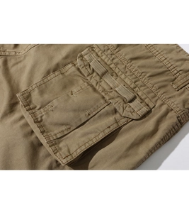 Close-up of khaki cargo shorts featuring 3D flap pockets and reinforced stitching