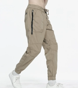 Detailed side view of khaki cargo joggers with large zip pockets and elastic cuffs