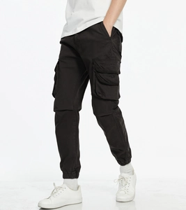 Detail view of cargo jogger pants showing side flap pockets and elastic cuffs in black