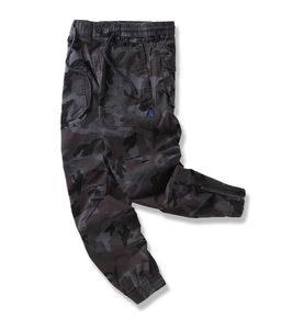 Close-up of camouflage joggers featuring elastic drawstring waist and side brand label